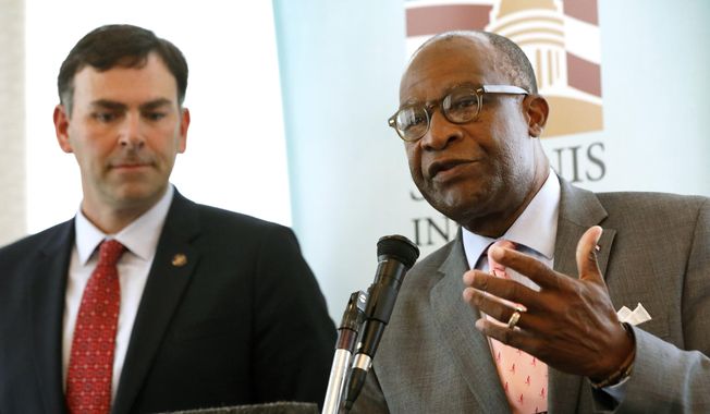 Republican Sen. Michael Watson of Pascagoula, left, listens as Democratic former Hattiesburg Mayor Johnny DuPree, responds to a question at a forum sponsored by Mississippi State University's Stennis Institute of Government and the Capitol Press Corps, Monday, Oct. 21, 2019, in Jackson, Miss. Both men are candidates for secretary of state. (AP Photo/Rogelio V. Solis)