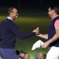 Tiger Woods of the United States, left, and Jason Day of Australia, right, hold their hands on the 18th hole after the Challenge: Japan Skins event ahead of the Zozo Championship PGA Tour at Accordia Golf Narashino C.C. in Inzai, east of Tokyo, Monday, Oct. 21, 2019. (AP Photo/Lee Jin-man)