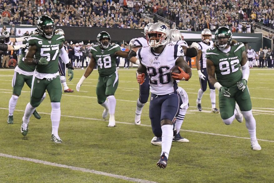 New England Patriots running back Sony Michel (26) gets away from New York Jets' C.J. Mosley (57) and Leonard Williams (92) for a touchdown during the first half of an NFL football game Monday, Oct. 21, 2019, in East Rutherford, N.J. (AP Photo/Bill Kostroun)