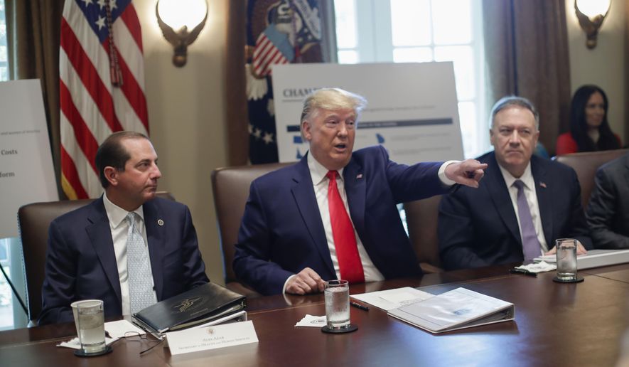 President Donald Trump, center, points to members of his Cabinet while speaking during a Cabinet meeting in the Cabinet Room of the White House, Monday, Oct. 21, 2019, in Washington, as Health and Human Services Secretary Alex Azar, left, and Secretary of State Mike Pompeo, right, listen. (AP Photo/Pablo Martinez Monsivais)
