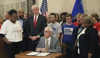 Gov. Tony Evers speaks at a news conference at Milwaukee City Hall signing an executive order calling a special session on gun laws, Monday, Oct. 21, 2019. (Michael Sears/Milwaukee Journal-Sentinel via AP)