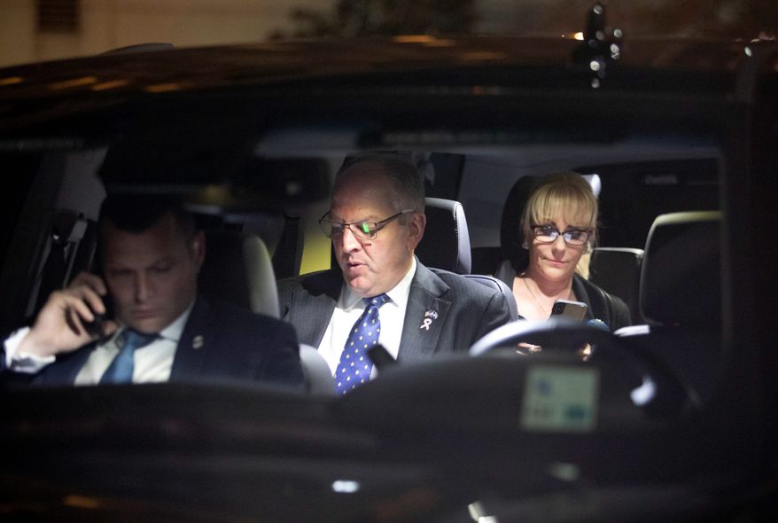 Louisiana Gov. John Bel Edwards, center, prepares to leave after speaks at his election night watch party in Baton Rouge, La., Saturday, Oct. 12, 2019. (AP Photo/Brett Duke)
