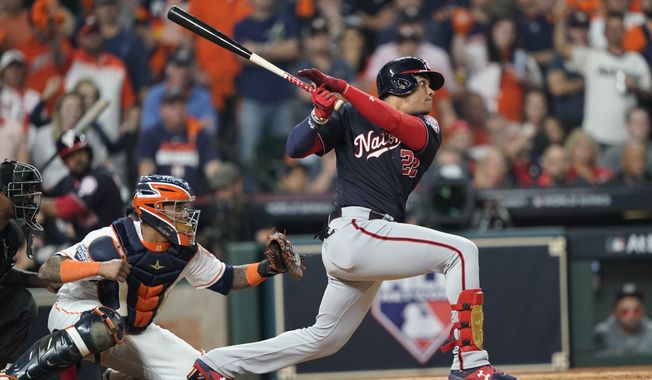 Washington Nationals&#x27; Juan Soto hits a two-run scoring double during the fifth inning of Game 1 of the baseball World Series against the Houston Astros Tuesday, Oct. 22, 2019, in Houston. (AP Photo/David J. Phillip)