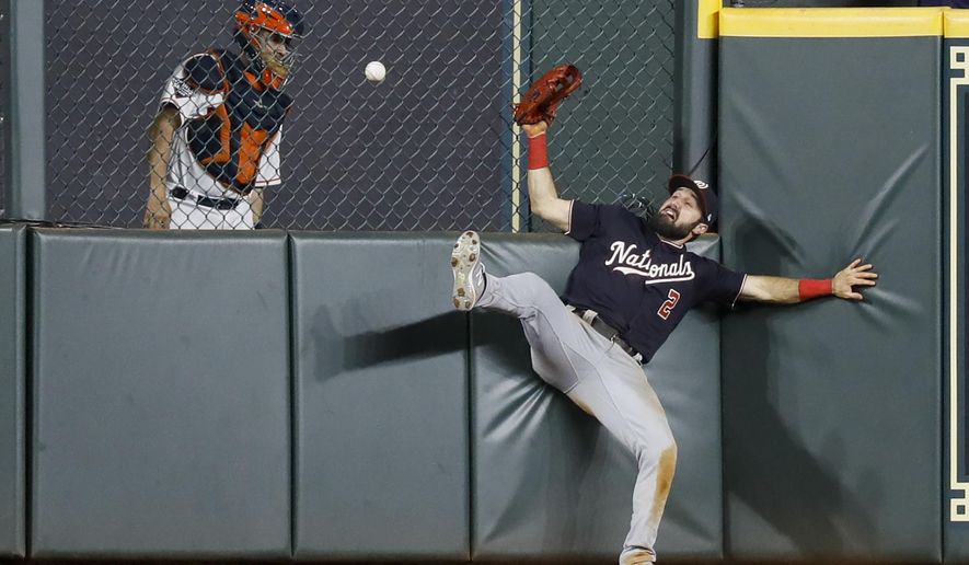 Washington Nationals right fielder Adam Eaton can't get a glove on a RBI-double by Houston Astros' George Springer during the eighth inning of Game 1 of the baseball World Series Tuesday, Oct. 22, 2019, in Houston. (AP Photo/Matt Slocum)