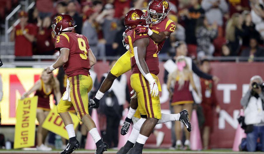 Southern California running back Kenan Christon (23) celebrates his rushing touchdown with offensive tackle Jalen McKenzie during the second half of an NCAA college football game against Arizona Saturday, Oct. 19, 2019, in Los Angeles. (AP Photo/Marcio Jose Sanchez)