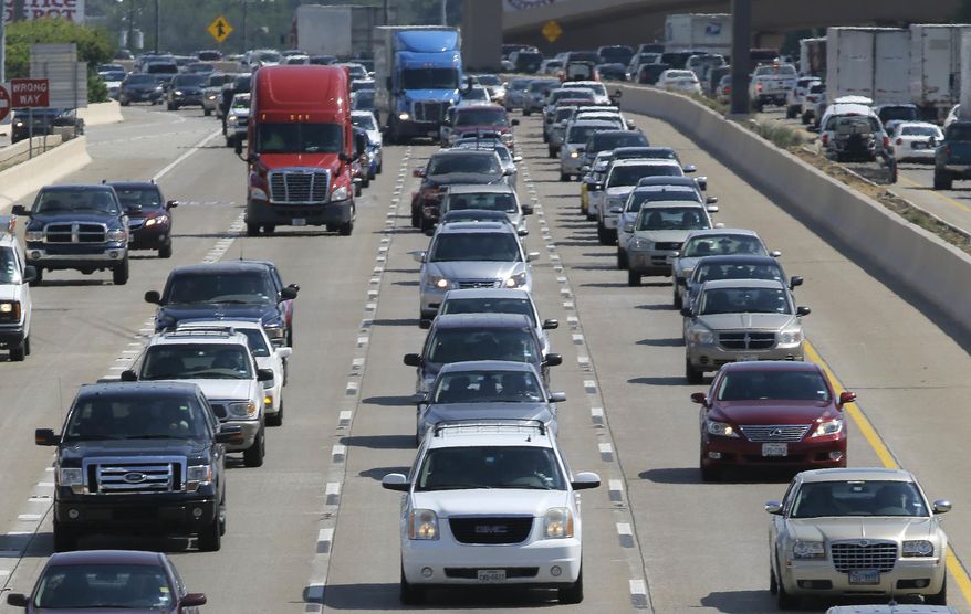 FILE - In this July 1, 2016 file photo, drivers work their way out of Dallas during rush hour. The U.S. government's road safety agency says traffic deaths fell by a small amount for the second straight year. The National Highway Traffic Safety Administration attributed the 2.4% drop partially to technology in newer vehicles that can prevent crashes. The agency says the downward trend is continuing into 2019. First-half estimates show fatalities down 3.4%. (AP Photo/LM Otero, File)