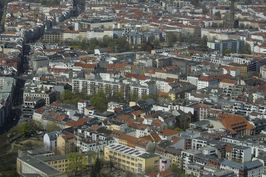 FILE - In this Thursday, April 4, 2019, file photo, Apartment buildings in the district Mitte photographed from the television tower in Berlin, Germany. Berlin's state government has agreed on a rent freeze for five years to counter rising rents in one of Germany's hottest real estate markets. (AP Photo/Markus Schreiber, file)