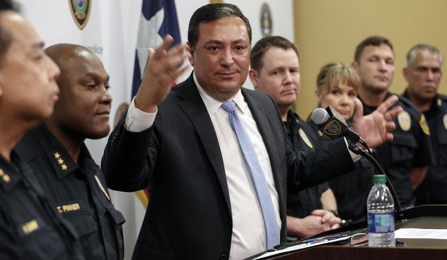 FILE - In this Aug. 23, 2019, file photo, Houston Police Chief Art Acevedo address charges against two police officers in the fatal drug raid in Houston. The Houston Police Department has created a new narcotics squad to serve high-risk warrants following the January botched drug raid that left two civilians dead and an officer charged with murder. (Steve Gonzales/Houston Chronicle via AP, File)