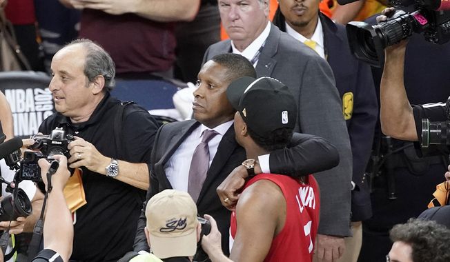 FILE - In this June 13, 2019, file photo, Toronto Raptors President Masai Ujiri, center left, walks with his arm around guard Kyle Lowry after the Raptors defeated the Golden State Warriors in basketball&#x27;s NBA Finals in Oakland, Calif. On Tuesday, Oct. 22, 2019, the Alameda County District Attorney&#x27;s Office announced no criminal charges will be filed against Ujiri for an incident involving Ujiri and an Alameda County sheriff&#x27;s deputy after Game 6 of the finals. (AP Photo/Tony Avelar, File)