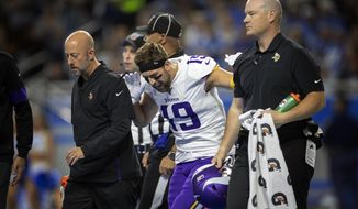 Minnesota Vikings wide receiver Adam Thielen (19) reacts after putting weight on his right leg, as he walks off the field with a hamstring injury in the first quarter of an NFL football game against the Detroit Lions, Sunday, Oct. 20, 2019, in Detroit. (Jerry Holt/Star Tribune via AP)