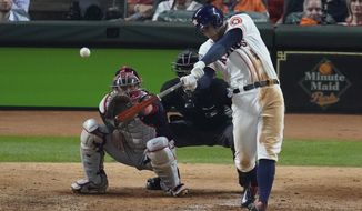 Houston Astros&#x27; George Springer hits an RBI double during the eighth inning of Game 1 of the baseball World Series against the Washington Nationals Tuesday, Oct. 22, 2019, in Houston. (AP Photo/Eric Gay)