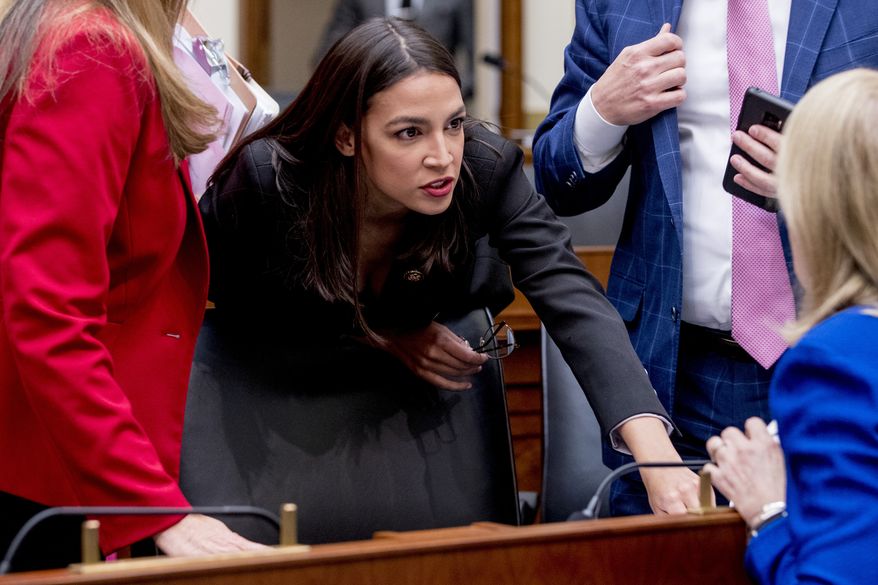 Rep. Alexandria Ocasio-Cortez, D-N.Y., speaks with other lawmakers during a break from testimony from Facebook CEO Mark Zuckerberg before a House Financial Services Committee hearing on Capitol Hill in Washington, Wednesday, Oct. 23, 2019, on Facebook&#39;s impact on the financial services and housing sectors. (AP Photo/Andrew Harnik)