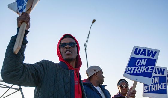 Motorline worker Ray Gladney of Florrisant, materials worker Brookes Robinson of Central West End, and Trim Doorline Worker Danielle Harris of Richmond Heights, picket at the General Motors plant in Wentzville, Mo., on Tuesday, Oct. 22, 2019. United Auto Workers around the country will be voting on whether to accept or deny the recent offer made to the union by GM in the coming week. (Troy Stolt/St. Louis Post-Dispatch via AP)