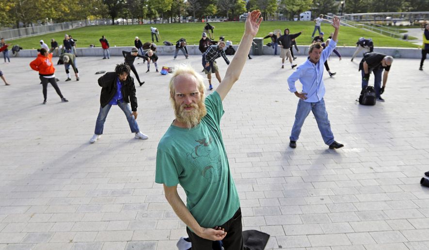 In this Oct. 2, 2019, photo, Whitey Christian performs tai chi at the Salt Lake Main Library, in Salt Lake City. The participants are homeless people who take part in a free tai chi program run by a retired couple who started the classes three years earlier. Now, more than 50 people regularly attend. (AP Photo/Rick Bowmer)