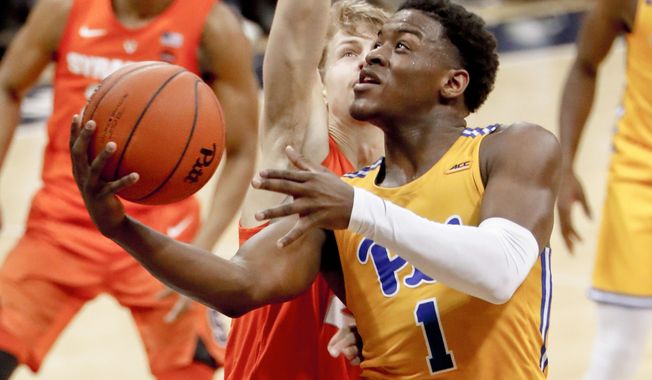 FILE—In this file photo from Feb. 2, 2019, Pittsburgh&#x27;s Xavier Johnson (1) shoots against Syracuse in an NCAA college basketball game in Pittsburgh. Johnson set a Pitt freshman scoring record last season while also being the only player in the ACC to average at least 15.5 points and 4.5 assists per game. New head coach Jeff Capel&#x27;s first season at Pittsburgh brought optimism. Now comes the hard part: building off it while playing in arguably the nation&#x27;s toughest conference. (AP Photo/Keith Srakocic, File)