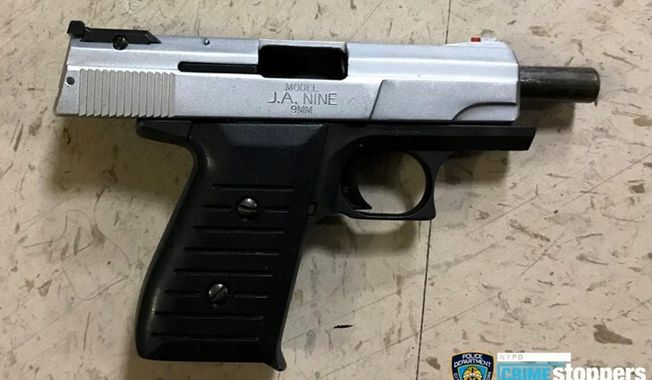 This photo provided by the New York Police Department shows a firearm recovered at the scene where police shot and killed a suspect early Wednesday, Oct. 23, 2019, in New York. A police officer, also shot during the incident, was in stable condition and is expected to survive. He was shot in the chest but was wearing a bullet-proof vest. (New York Police Department via AP)