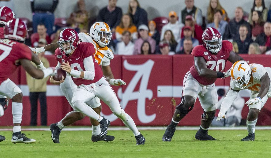 Alabama quarterback Mac Jones (10) carries the ball against Tennessee during the second half of an NCAA college football game Saturday, Oct. 19, 2019, in Tuscaloosa, Ala. (AP Photo/Vasha Hunt)