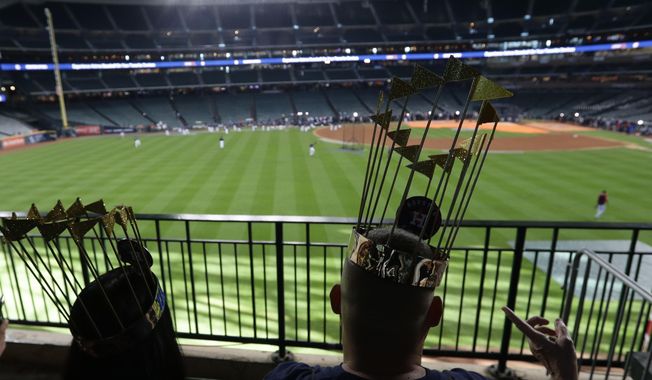Fans watch batting practice before Game 2 of the baseball World Series between the Houston Astros and the Washington Nationals Wednesday, Oct. 23, 2019, in Houston. (AP Photo/Eric Gay)