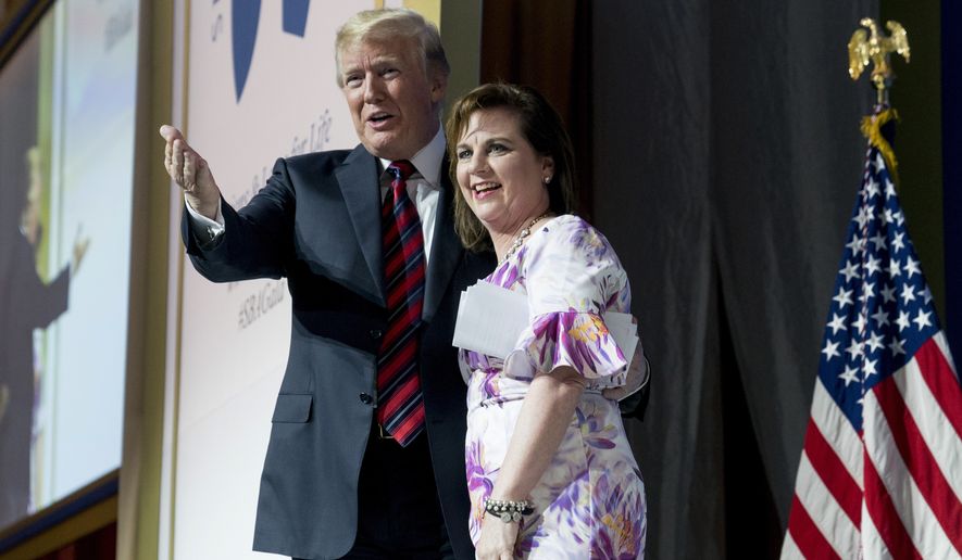 In this May 22, 2018, file photo, Susan B. Anthony List President Marjorie Dannenfelser, right, stands with President Donald Trump at the Susan B. Anthony List 11th Annual Campaign for Life Gala at the National Building Museum in Washington. The SBA List has made endorsements in 11 U.S. House races in the 2020 general election cycle. (AP Photo/Andrew Harnik, File)  **FILE**