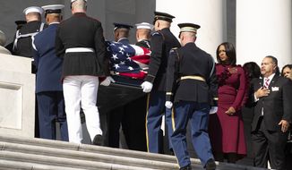 The casket of Rep. Elijah Cummings is carried up the East Front steps of the U.S. Capitol, as widow Maya Rockeymoore, second from right and family members watch Thursday, Oct. 24, 2019, in Washington. (Michael Reynolds/Pool via AP)