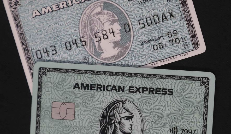 In this Wednesday, Oct. 23, 2019, file photo the original American Express &#x27;Green Card&#x27; top, shown with the latest version of the card in New York.  (AP Photo/Bebeto Matthews) **FILE**