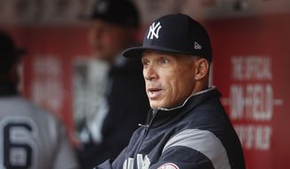  In this May 9, 2017 file photo, New York Yankees manager Joe Girardi, left, works in the dugout before the first inning of a baseball game against the Cincinnati Reds in Cincinnati. Person familiar with deal tells AP the Philadelphia Phillies are hiring Girardi as manager, Thursday, Oct. 24, 2019.   (AP Photo/John Minchillo, File)  **FILE**