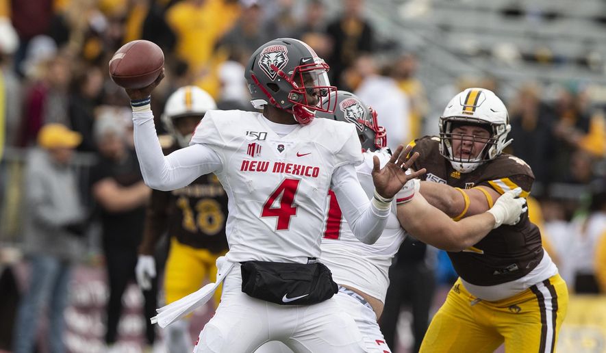 FILE - In this Oct. 19, 2019 file photo, New Mexico quarterback Sheriron Jones (4) throws a pass against Wyoming during an NCAA college football game in Laramie, Wy. New Mexico has suspended Jones indefinitely from the team for undisclosed reasons. (AP Photo/Michael Smith, File)