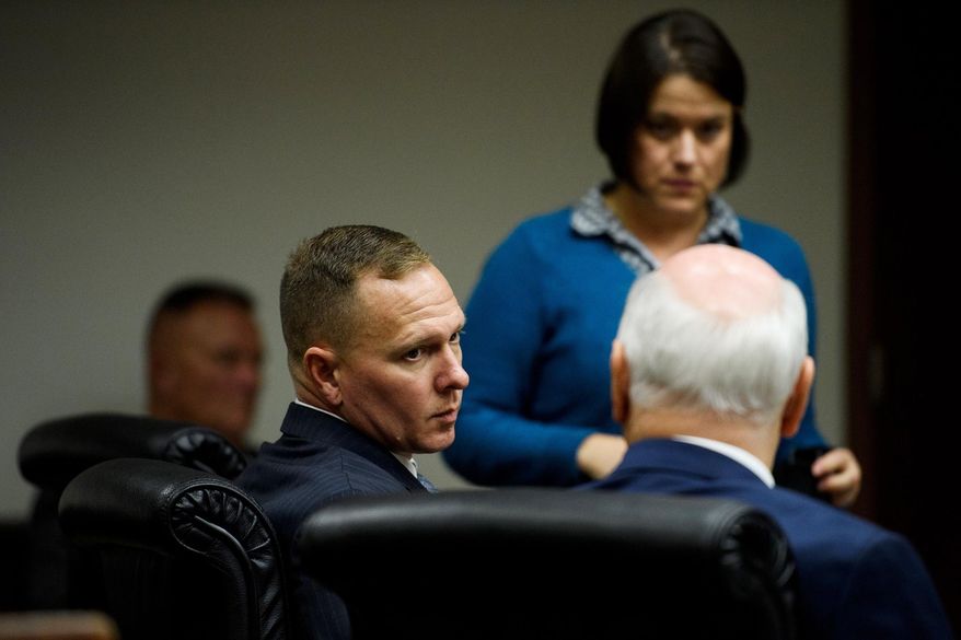Suspended Greenville Sheriff Will Lewis speaks to his attorney, Rauch Wise, before court resumes on Thursday afternoon, Oct. 24, 2019, in Greenville, S.C. Lewis, 43, said he did not plan to have sex with his young female assistant at an out-of-town budget conference, but one thing led to another after they went out for drinks and ended up in her hotel room. (Josh Morgan/The Greenville News via AP, Pool)