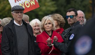 Actress and activist Jane Fonda, joined at left by actor Ted Danson, is arrested at the Capitol for blocking the street after she and other demonstrators called on Congress for action to address climate change, in Washington, Friday, Oct. 25, 2019. (AP Photo/J. Scott Applewhite)