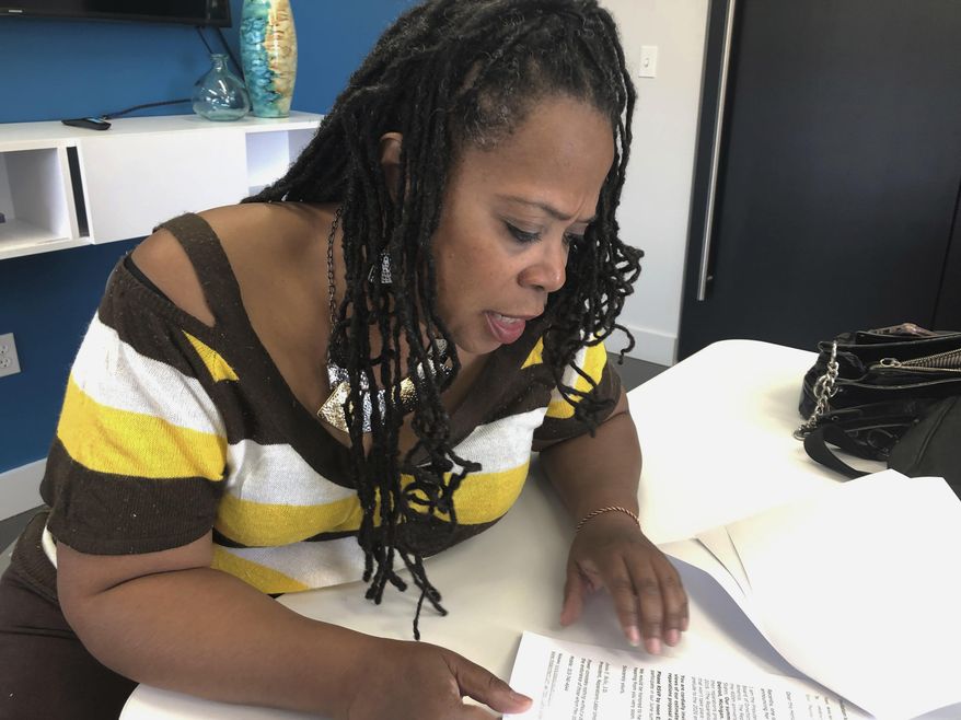 In this April 10, 2019, file photo, Reparations Labor Union founder Anita Belle talks about slave reparations during an interview in Detroit. Few Americans are in favor of giving reparations to descendants of enslaved black people in the United States, a new poll shows. The Associated Press-NORC Center for Public Affairs Research poll also finds that most Americans think the legacy of slavery has at least some impact on black Americans today. (AP Photo/Corey Williams, File)