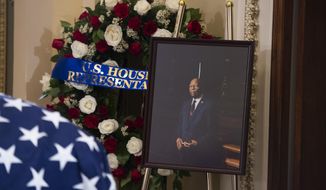 A portrait of the late Rep. Elijah Cummings, D-Md., sits nearby as his remains lie in state outside the House Chamber at the Capitol on Thursday, Oct. 24, 2019 in Washington. (Tom Williams/Pool via AP)