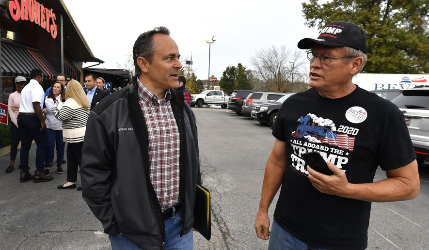 Kentucky Governor and Republican candidate Matt Bevin, left talks with a supporter during the first stop of his campaign bus tour in Elizabethtown, Ky., Friday, Oct. 25, 2019. (AP Photo/Timothy D. Easley)