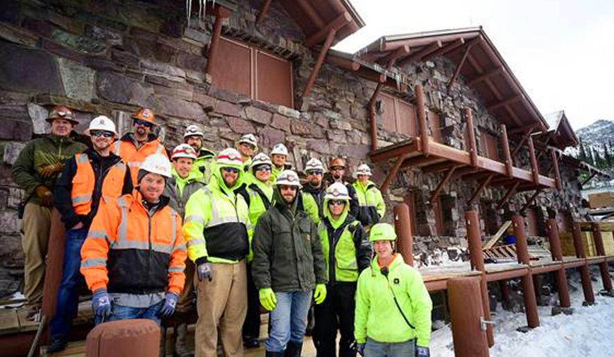 In this Oct. 2, 2019 photo, the Dick Anderson Construction crew poses on the steps of the newly rebuilt Sperry Chalet in Glacier National Park, Mont. Crews left the site on Oct. 11 after a second summer of work on the 105-year-old chalet, which was gutted by a fire in August 2017. The work cost $8.8 million. Reservations will be taken on Jan. 13, 2020, for next summer. (Chris Peterson/The Daily Inter Lake via AP)