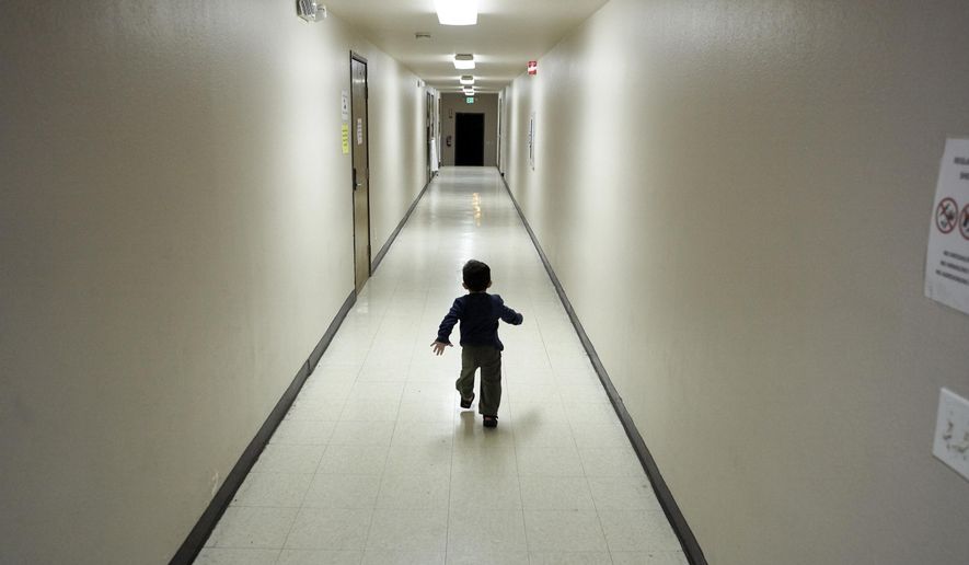 In this Dec. 11, 2018 file photo, an asylum-seeking boy from Central America runs down a hallway after arriving from an immigration detention center to a shelter in San Diego. (AP Photo/Gregory Bull) **FILE**