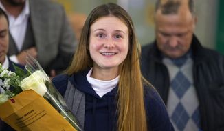 Russian agent Maria Butina smiles as she speaks to journalists upon her arrival from the United States at Moscow International Airport Sheremetyevo outside Moscow Moscow, Russia, Saturday, Oct. 26, 2019. Butina, a gun rights activist who sought to infiltrate conservative U.S. political groups and promote Russia&#39;s agenda around the time that Donald Trump rose to power, was released Friday from a low-security facility in Florida. (AP Photo/Alexander Zemlianichenko)