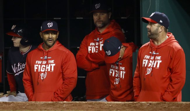 Members of the Washington Nationals watch during the seventh inning of Game 4 of the baseball World Series against the Houston Astros Saturday, Oct. 26, 2019, in Washington. (AP Photo/Patrick Semansky)