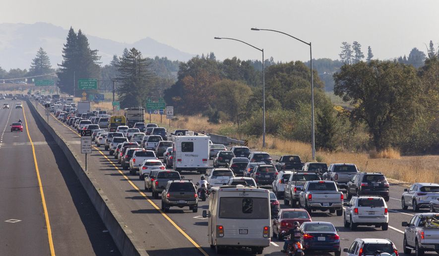 Traffic is backed up heading South on Highway 101 during mandatory evacuations due to predicted danger from the Kincade Fire, in Windsor, Calif., on Saturday, Oct. 26, 2019. The entire communities of Healdsburg and Windsor were ordered to evacuate ahead of strong winds that could lead to erratic fire behavior near the blaze burning in wine country. (Darryl Bush/The Press Democrat via AP)