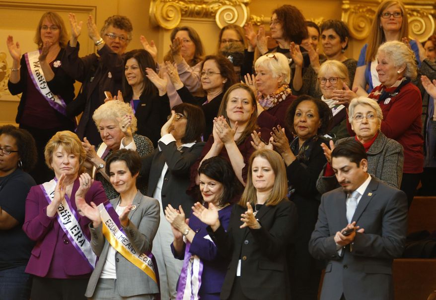 FILE - In this Thursday Feb. 21, 2019 file photo State Senators Janet Howell, D-Fairfax, front left, Jennifer Boysko, D-Fairfax, second from left, and Sen. Barbara Favola, D-Arlington third from left, applaud a speech along with other ERA supporters in the gallery of the the House of Delegates at the Capitol in Richmond, Va., Democrats hoping to seize control of the Virginia Legislature in the 2019 elections say passing the long-stalled Equal Rights Amendment will be a top priority next year. (AP Photo/Steve Helber)