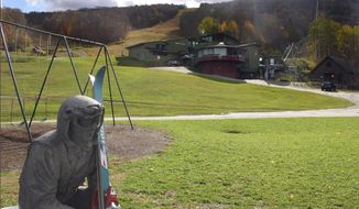In this Oct. 23, 2019, photo, a sculpture of a skier and slopes, rear, await the ski season at Sugarbush Resort in Warren, Vt. In the tight labor market, ski areas are having a tough time hiring seasonal workers so they&#39;re upping the ante by boosting wages, offering more worker housing and other incentives. (AP Photo/Lisa Rathke)