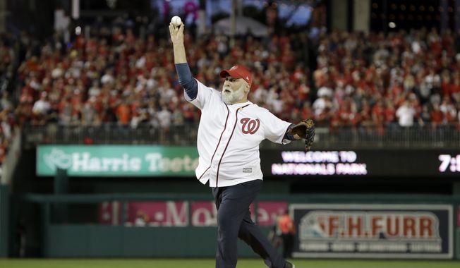 Chef Jose Andres throws out the first pitch before Game 5 of the baseball World Series between the Houston Astros and the Washington Nationals Sunday, Oct. 27, 2019, in Washington. (AP Photo/Jeff Roberson)