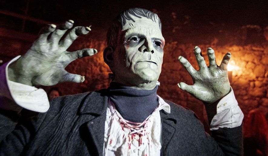 An actor depicting Frankenstein poses in the medieval Frankenstein Castle about 35 kilometers (22 miles) south of Frankfurt, Germany Saturday, Oct. 26, 2019. For 42 years the castle stages spooky Halloween events with monsters and live shows on three weekends around Halloween. (AP Photo/Michael Probst)