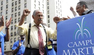 FILE - In an Aug. 24, 2010 file photo, Congressman John Conyers, left, greets the Rev. Jesse Jackson, right, as postal workers rally to save Saturday mail service at the Campus Martius Park, in Detroit. Detroit police say the former congressman died at his home on Sunday, Oct. 27, 2019. He was 90.(Clarence Tabb, Jr./Detroit News via AP, File)