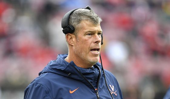 Virginia head coach Bronco Mendenhall in action during the first half of an NCAA college football game in Louisville, Ky., Saturday, Oct. 26, 2019. (AP Photo/Timothy D. Easley) **FILE**