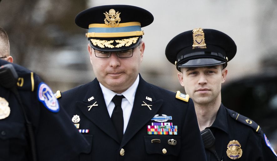 Army Lieutenant Colonel Alexander Vindman, a military officer at the National Security Council, center, arrives on Capitol Hill in Washington, Tuesday, Oct. 29, 2019, to appear before a House Committee on Foreign Affairs, Permanent Select Committee on Intelligence, and Committee on Oversight and Reform joint interview with the transcript to be part of the impeachment inquiry into President Donald Trump. (AP Photo/Manuel Balce Ceneta)