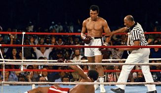 In this Oct. 30, 1974 file photo, referee Zack Clayton, right, steps in after challenger Muhammad Ali looks on after knocking down defending heavyweight champion George Foreman in the eighth round of their championship bout in Kinshasa, Zaire. Ali regained the world heavyweight crown by knockout in the eighth round of the fight dubbed &quot;Rumble in the Jungle.&quot; (AP Photo/File) **FILE**

