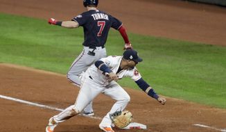 Washington Nationals&#39; Trea Turner knocks the glove away from Houston Astros first baseman Yuli Gurriel during the seventh inning of Game 6 of the baseball World Series Tuesday, Oct. 29, 2019, in Houston. (AP Photo/Sue Ogrocki)