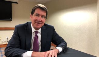 Republican U.S. Senate candidate Bill Hagerty poses for a photo after an Associated Press interview at a regional meeting of the Conservative Political Action Conference Tuesday, Oct. 29, 2019, in Memphis, Tenn. Hagerty is not wavering from his staunch support of President Donald Trump, defending him from Democrats&#39; impeachment efforts while heaping praise on the president for his handling of the economy and the killing of Islamic State leader Abu Bakr al-Baghdadi. (AP Photo/Adrian Sainz)