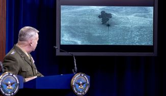 Video of the Abu Bakr al-Baghdadi raid is displayed as U.S. Central Command Commander Marine Gen. Kenneth McKenzie speaks, Wednesday, Oct. 30, 2019, at a joint press briefing at the Pentagon in Washington. (AP Photo/Andrew Harnik)