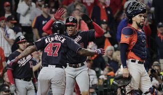 Washington Nationals&#39; Howie Kendrick is congratulated by Juan Soto after hitting a two-run home run during the seventh inning of Game 7 of the baseball World Series against the Houston Astros Wednesday, Oct. 30, 2019, in Houston. (AP Photo/David J. Phillip)