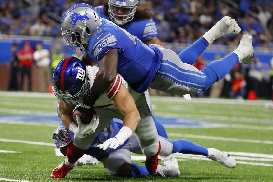 New York Giants tight end Rhett Ellison is tackled by Detroit Lions middle linebacker Jarrad Davis (40) during the second half of an NFL football game, Sunday, Oct. 27, 2019, in Detroit. (AP Photo/Paul Sancya)